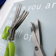 Stainless steel kitchen scissors for cutting, shredding, and chopping ingredients.